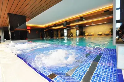 a large pool of water in a hotel at Lovely Modern 1BD Condo Views w PoolGym! #222 in Istanbul