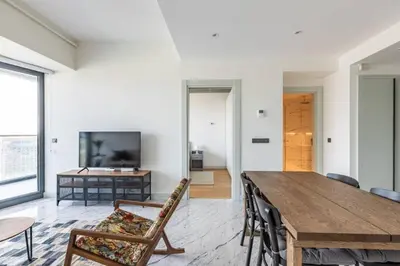 a living room with a wooden table and chairs at Gorgeous Modern 1BD Terrace CondoPoolViews! #233 in Istanbul