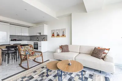 a living room with a couch and a table at Gorgeous Modern 1BD Terrace CondoPoolViews! #233 in Istanbul