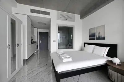 a white bedroom with a large bed in a room at Cool Bright Studio w Parking PoolViews! #238 in Istanbul