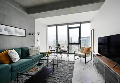 a living room with a couch and a tv at Cool Bright Studio w Parking PoolViews! #238 in Istanbul