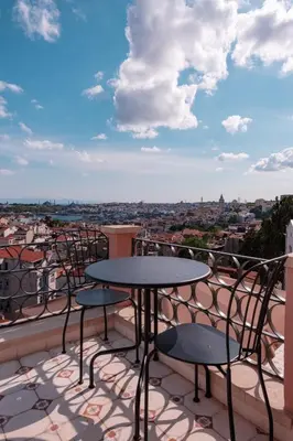 a patio with tables and chairs on a balcony at Homie Suites - Turna Residences in Cihangir in Istanbul