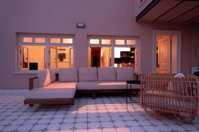 a living room with a couch on a patio at Homie Suites - Turna Residences in Cihangir in Istanbul