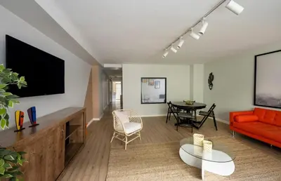 a living room with a red couch and a table at Modern Prime Location 2BD1Bath Cozy Home! #213 in Istanbul