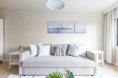 a white living room with a gray couch at Modern Prime Location 1Bed Bright Home! #243 in Istanbul