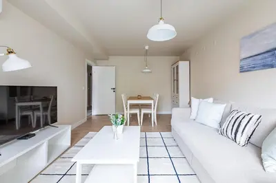 a living room with a white couch and a table at Modern Prime Location 1Bed Bright Home! #243 in Istanbul