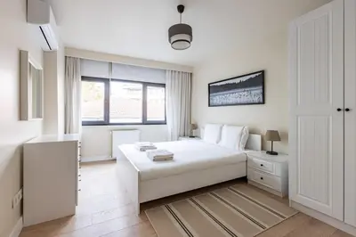 a white bedroom with a white bed and a window at Modern Prime Location 1Bed Bright Home! #243 in Istanbul