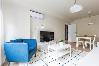 a living room with a blue chair and a table at Modern Prime Location 1Bed Bright Home! #243 in Istanbul
