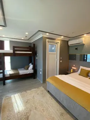 a bedroom with two beds and a bunk bed at Sahrakent Otel Pendik in Istanbul