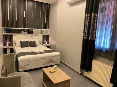 a hotel room with a bed and a table at Sahrakent Otel Pendik in Istanbul
