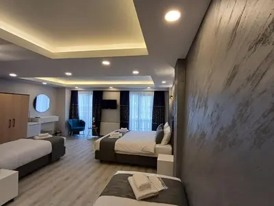 a hotel room with two beds and a couch at White Palace Haliç in Istanbul