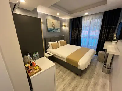 a hotel room with a bed and a desk and window at White Palace Haliç in Istanbul