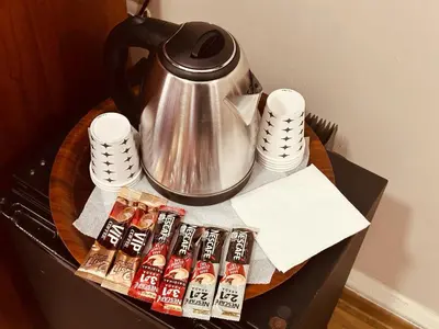 a table with a tea kettle and packets of hot sauce at YUNUS OTEL in Istanbul