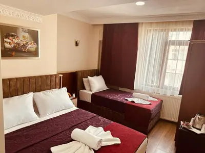 a hotel room with two beds and a window at YUNUS OTEL in Istanbul