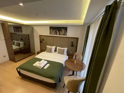 a hotel room with a bed and a table and a window at Elegance Suites in Istanbul
