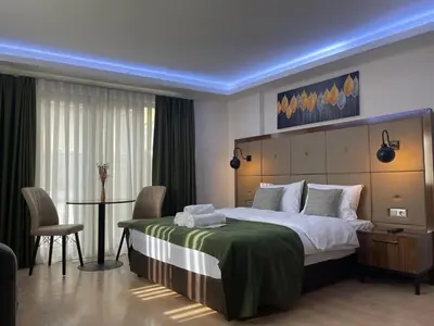 a bedroom with a large bed and a table and chairs at Elegance Suites in Istanbul