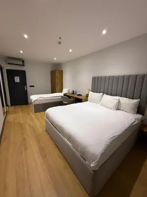 a hotel room with a large bed and a desk at Business Life Hotel Güneşli in Istanbul