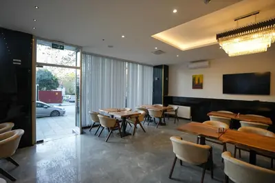 a dining room with wooden tables and chairs at Business Life Hotel Güneşli in Istanbul