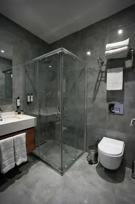 a bathroom with a shower and a toilet and a sink at Business Life Hotel Güneşli in Istanbul