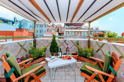 a patio with a table and chairs on a balcony at Walnut Shell Hotel in Istanbul