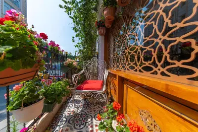 a balcony with a bench and flowers on a building at Walnut Shell Hotel in Istanbul