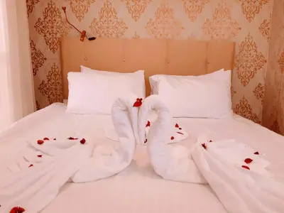 a bed with two towels shaped like hearts on it at Walnut Shell Hotel in Istanbul