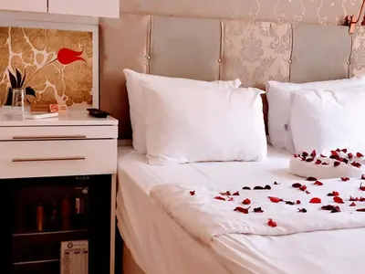 a bed with red hearts on it with a night stand at Walnut Shell Hotel in Istanbul