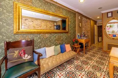 a living room with a couch and a mirror at Walnut Shell Hotel in Istanbul