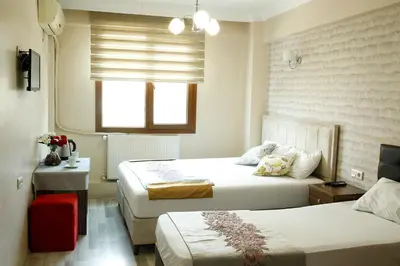 a hotel room with two beds and a window at Birlik Apart Hotel in Istanbul