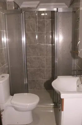 a bathroom with a toilet and a shower and a sink at Birlik Apart Hotel in Istanbul