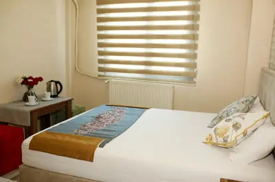 a bedroom with a large bed with a window at Birlik Apart Hotel in Istanbul
