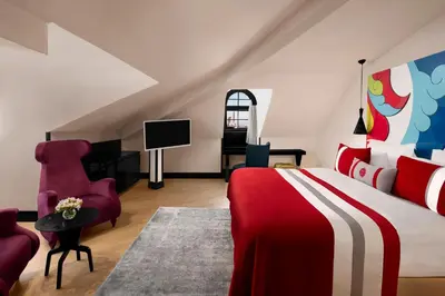 a bedroom with a red and white bed and a tv at Sura Hagia Sophia Hotel in Istanbul