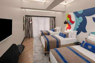 a hotel room with two beds and a flat screen tv at Sura Hagia Sophia Hotel in Istanbul