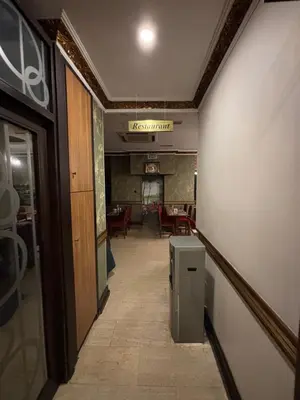 a hallway leading to a dining room with a table at Nil Hotel İstanbul City Center in Istanbul