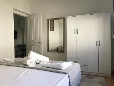 a bedroom with a bed with white cabinets and a mirror at Apartment sultanahmet in Istanbul