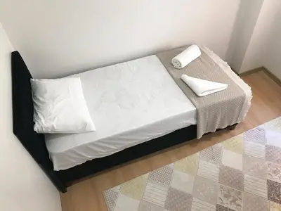 a small bed with white sheets and pillows on it at Apartment sultanahmet in Istanbul