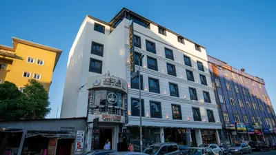 a tall white building on a city street at GRAND MOON HOTEL in Esenyurt