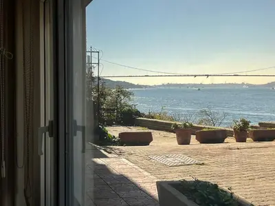 an open door with a view of the ocean at Bosphorus waterfront flat, Cengelköy in Istanbul