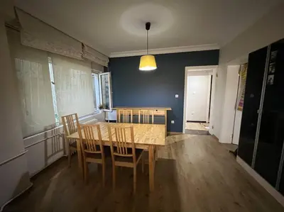 a dining room with a wooden table and chairs at Bosphorus waterfront flat, Cengelköy in Istanbul
