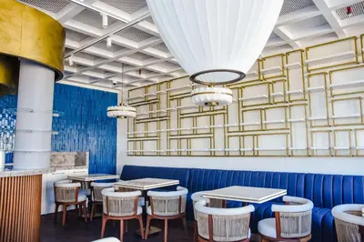 a dining room with tables and stools at Park Inn by Radisson Yalova City Center in Yalova