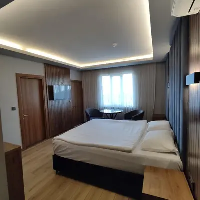 a bedroom with a bed and a table with chairs at Hotel And free shuttle in Istanbul