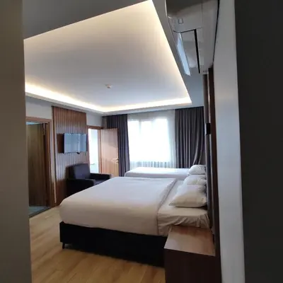 a hotel room with a large bed and a window at Hotel And free shuttle in Istanbul