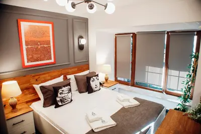 a bedroom with a white bed and two windows at Istiklal Street Taksim House Yamalya Hotel in Istanbul