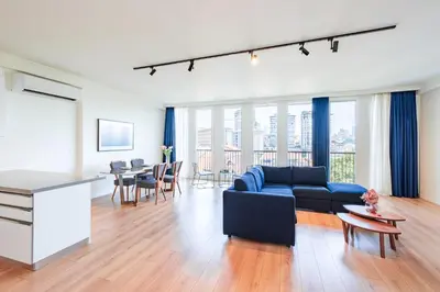 a living room with a blue couch and a table at Homie Suites - Luxury Apartments in Maçka in Istanbul