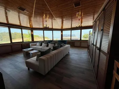 a large room with couches and tables and windows at Olinda Hotel & Spa in Sile