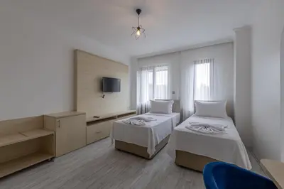 a hotel room with two beds and a tv at Olinda Hotel & Spa in Sile