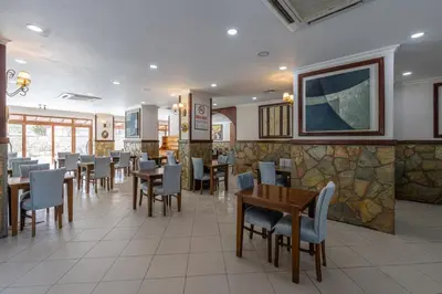 a dining room with tables and chairs in a restaurant at Olinda Hotel & Spa in Sile