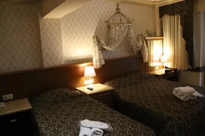a hotel room with two beds and a chandelier at Grand Peninsula Hotel in Istanbul
