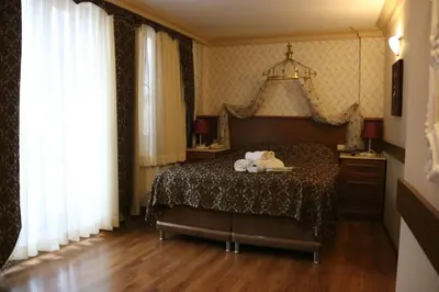 a bedroom with a bed with two stuffed animals on it at Grand Peninsula Hotel in Istanbul