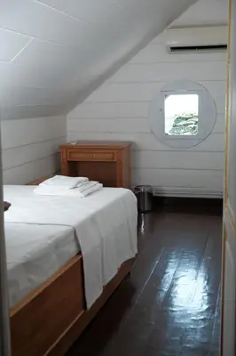 a bedroom with a white bed and a window at Laden Palas Prince's Island Historical Mansion in Adalar